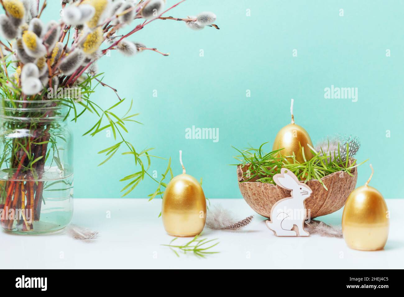 Happy Easter background, spring-time concept. Golden eggs, nests and bunny toys on blue Stock Photo