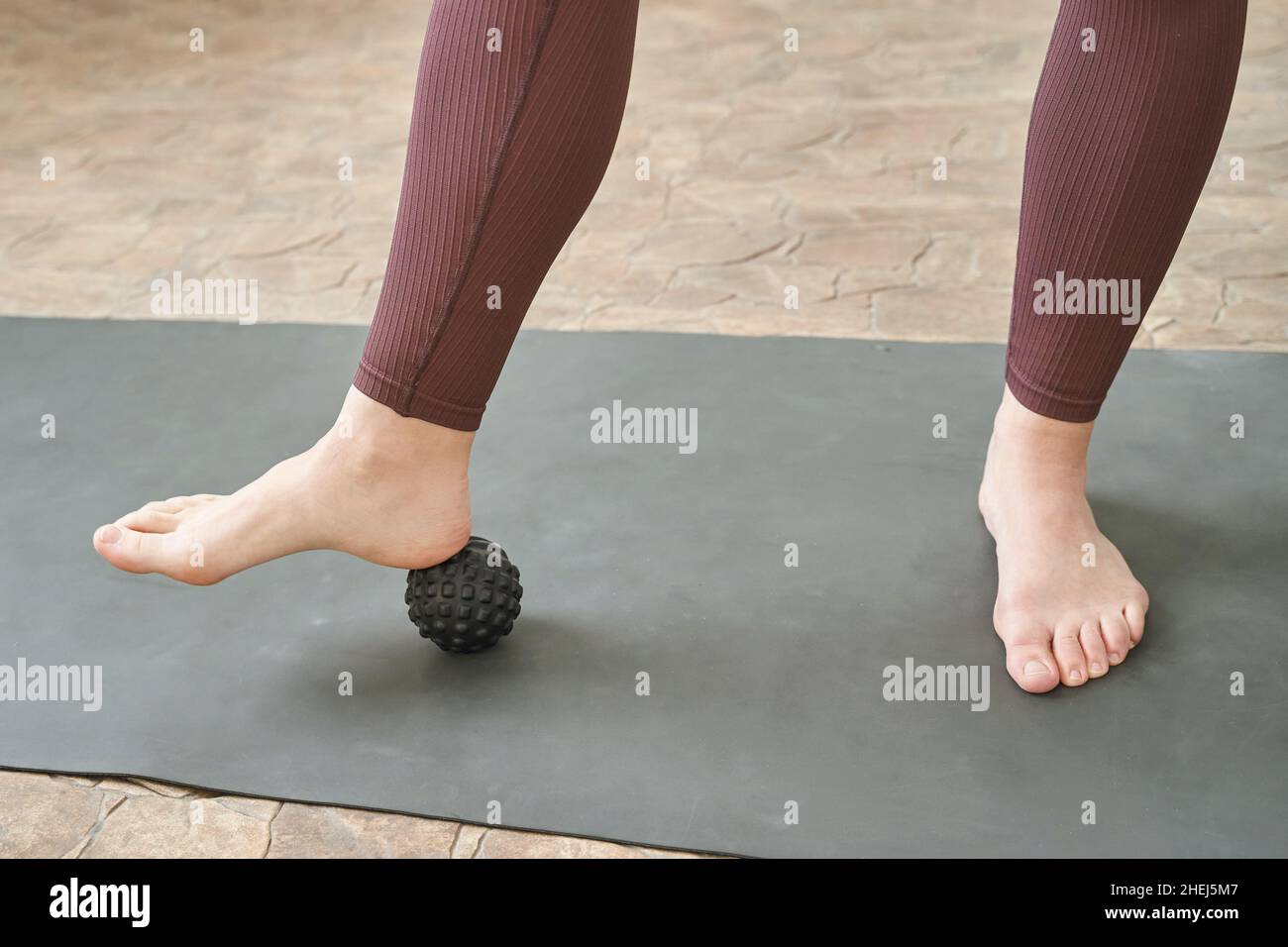 Young woman stretch body on fitness mat. Myofascial release massage. Relax Stock Photo