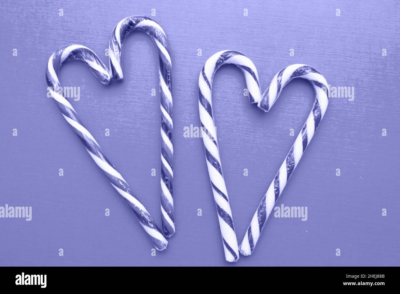 Two striped heart shaped lollipops on the background, Very Pure tone image. Valentines Day. copy space Stock Photo