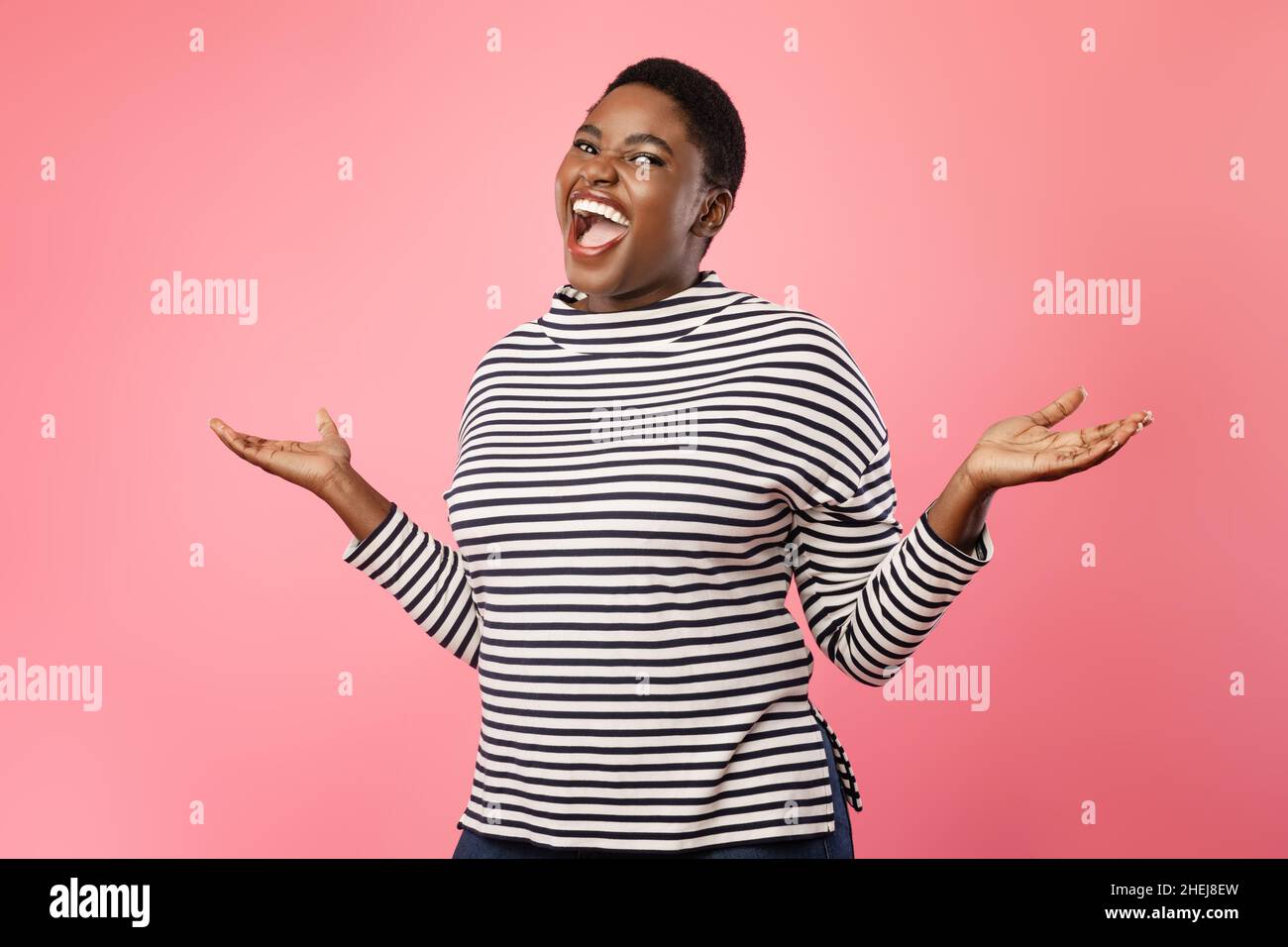 Overweight Black Lady Laughing And Shrugging Shoulders Over Pink Background Stock Photo