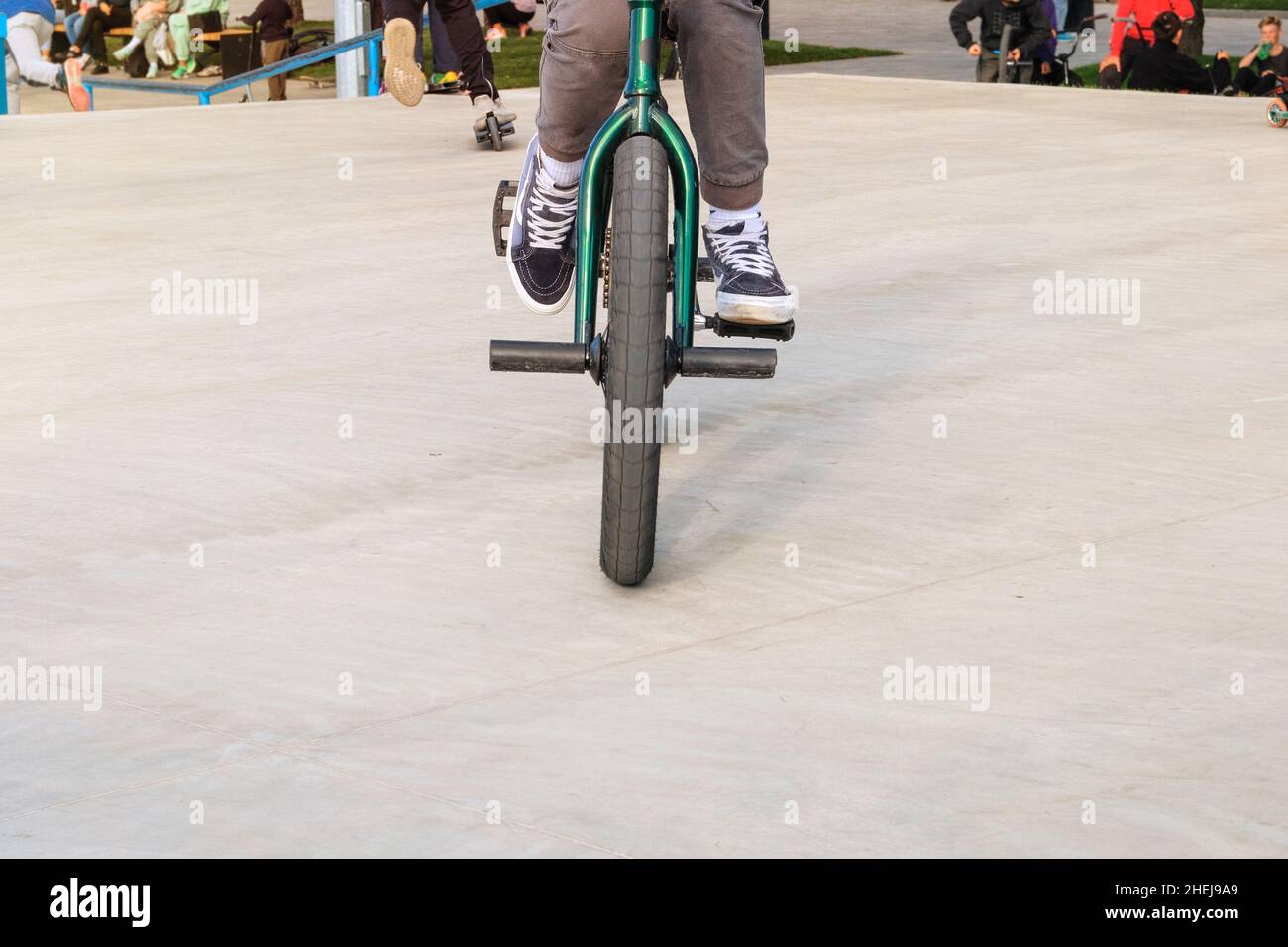 Extreme bike rider jumping in skate park in city. Active urban life