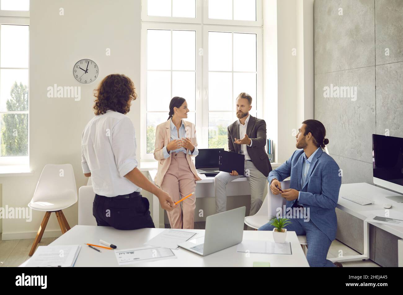 Group of employees talking about a business project they are working on together Stock Photo