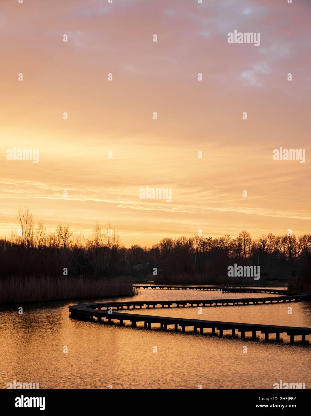 Boardwalk at Zuidpolder park in Barendrecht, the Netherlands during sunrise Stock Photo