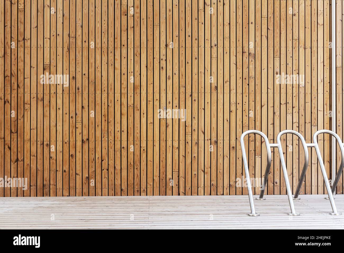 New vertical wooden plank wall and a bike stand Stock Photo