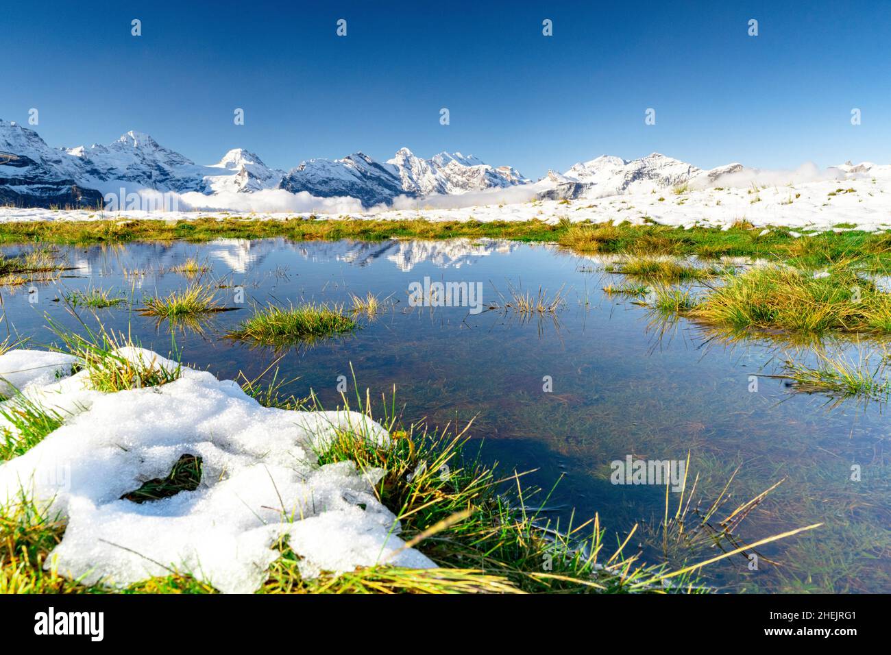 Breithorn and snowcapped mountains reflected in the alpine lake, Mannlichen, Jungfrau Region, Bern canton, Switzerland Stock Photo