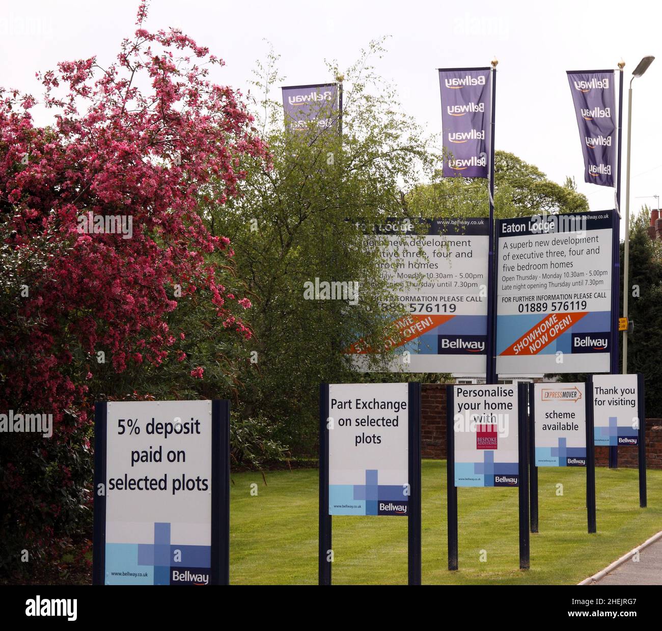 Signs outside Bellway Homes housing development encouraging buyers, deals, deposits paid, 2010 Stock Photo