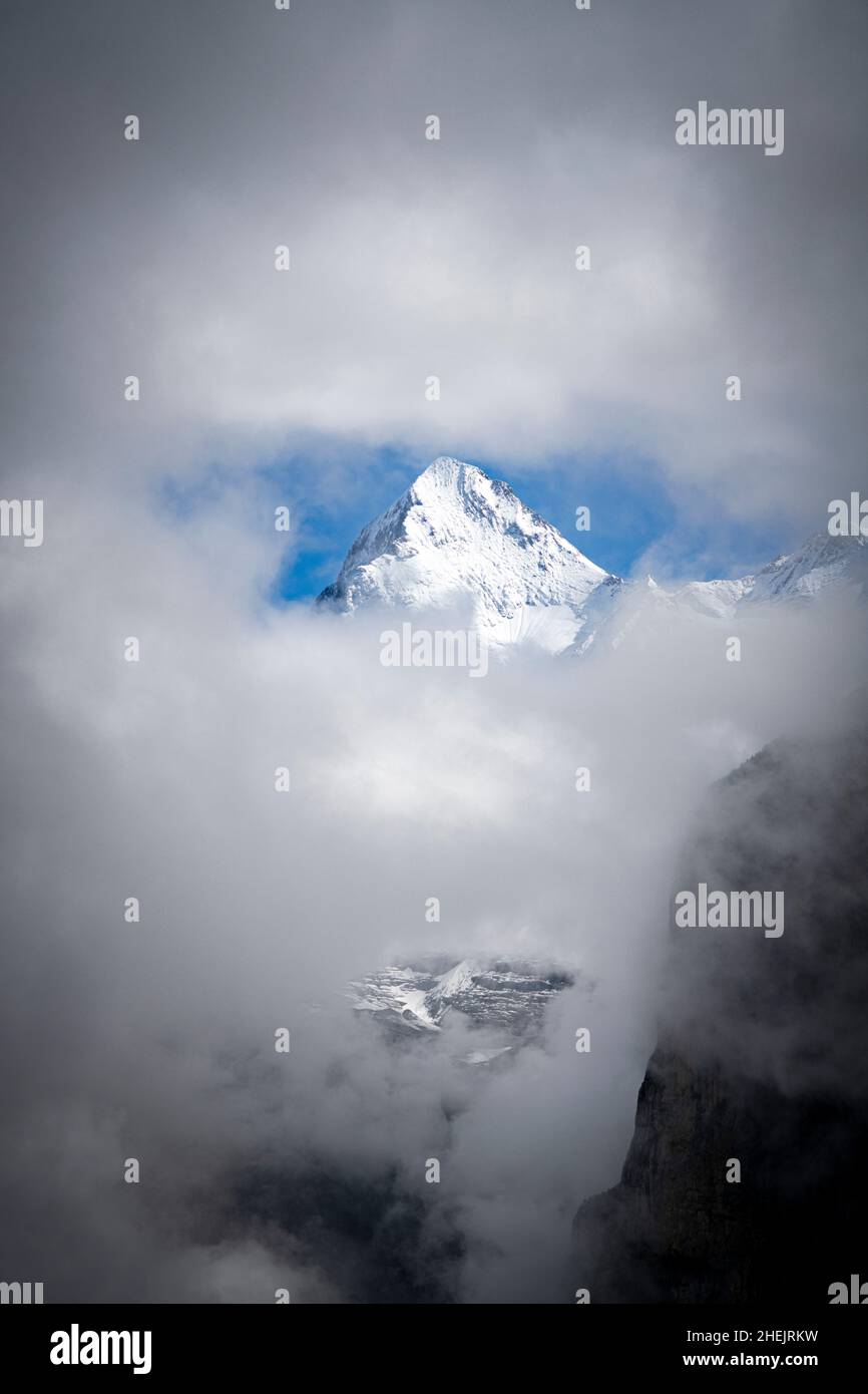 Snowcapped peak of mount Eiger emerging from morning fog, Murren, Jungfrau Region, Bern canton, Switzerland Stock Photo