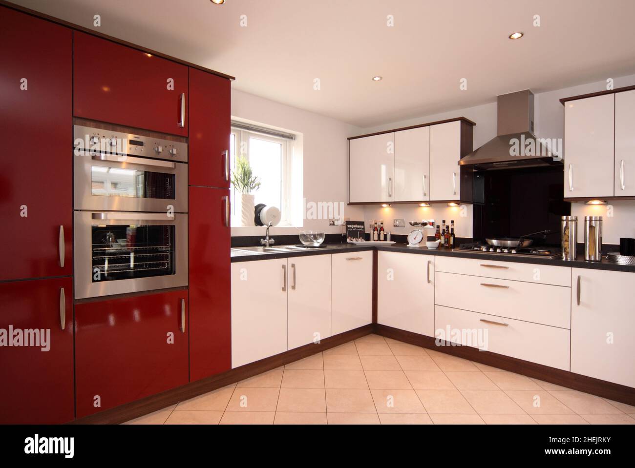 Kitchen in modern new build house,red and white kitchen units,cooker ...