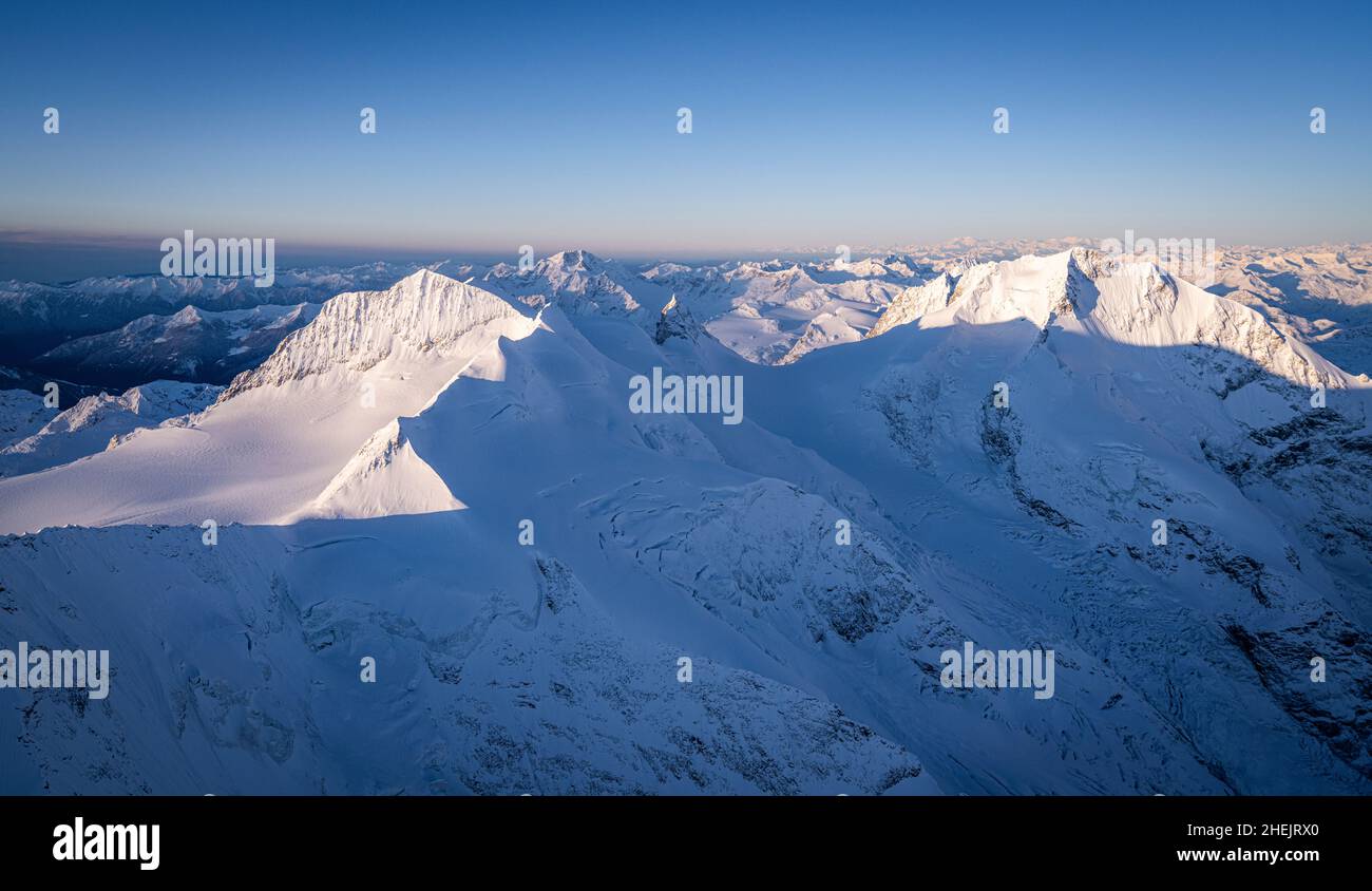 Aerial view of Bellavista, Piz Zupo, Monte Disgrazia and Piz Bernina peaks covered with snow, Graubunden, Engadine, Switzerland Stock Photo