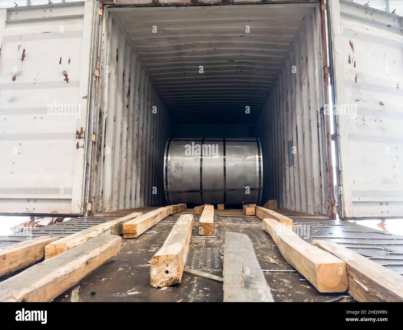 Loading master coil steel out of container Stock Photo