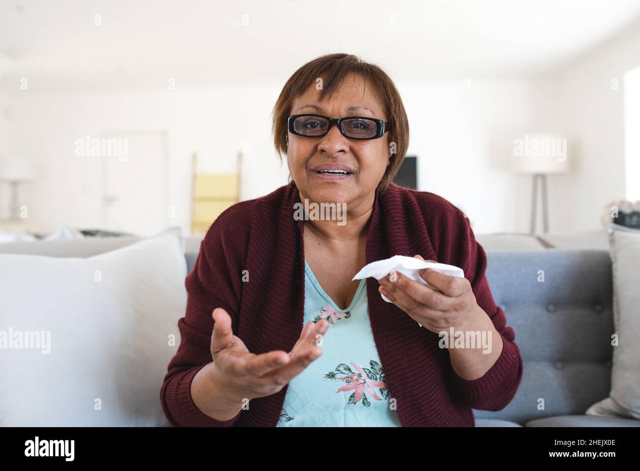 Portrait of african american senior woman suffering from cold and flu at home Stock Photo