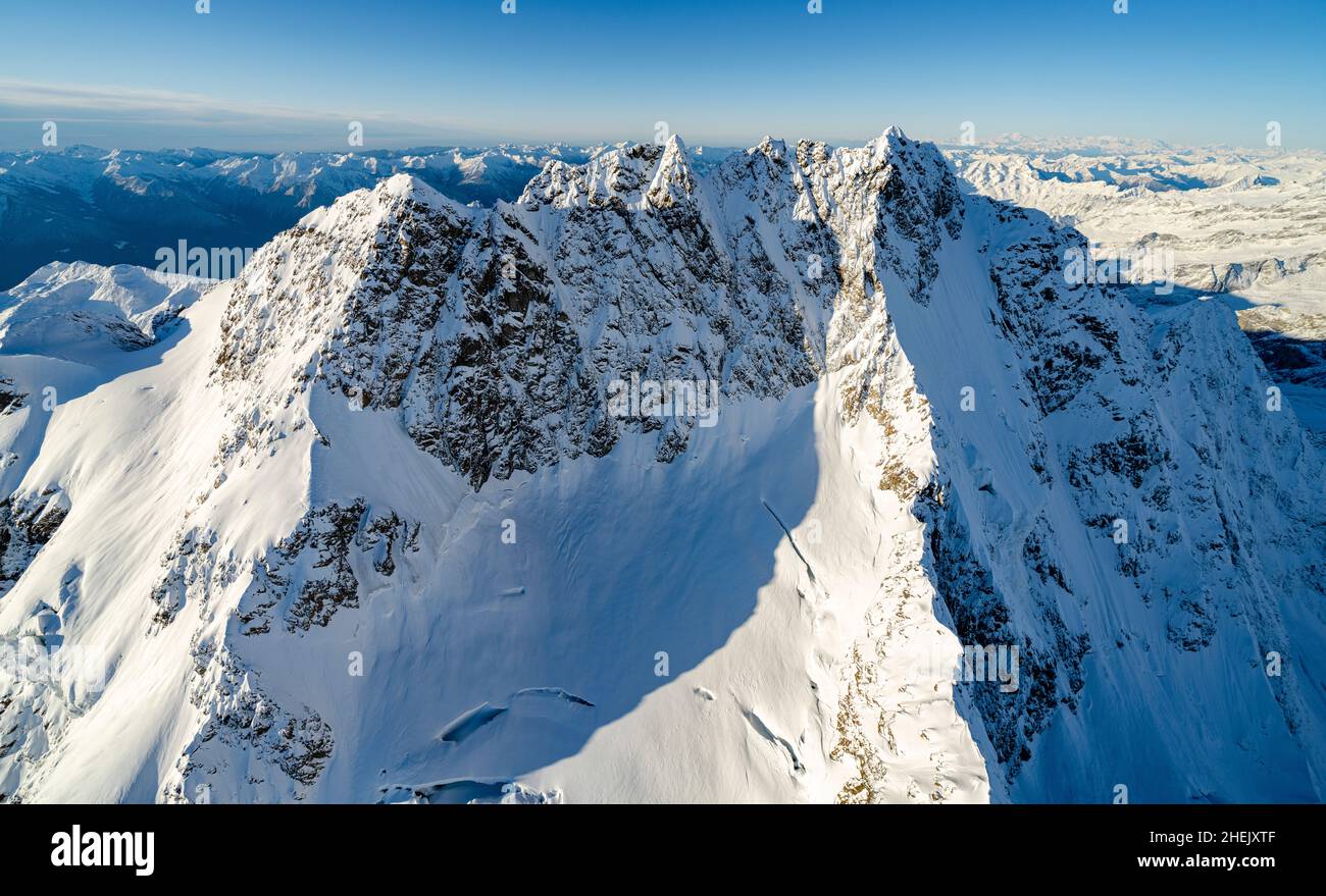 Aerial view of majestic peak of Monte Disgrazia covered with snow, Valmalenco, Sondrio province, Valtellina, Lombardy, Italy Stock Photo