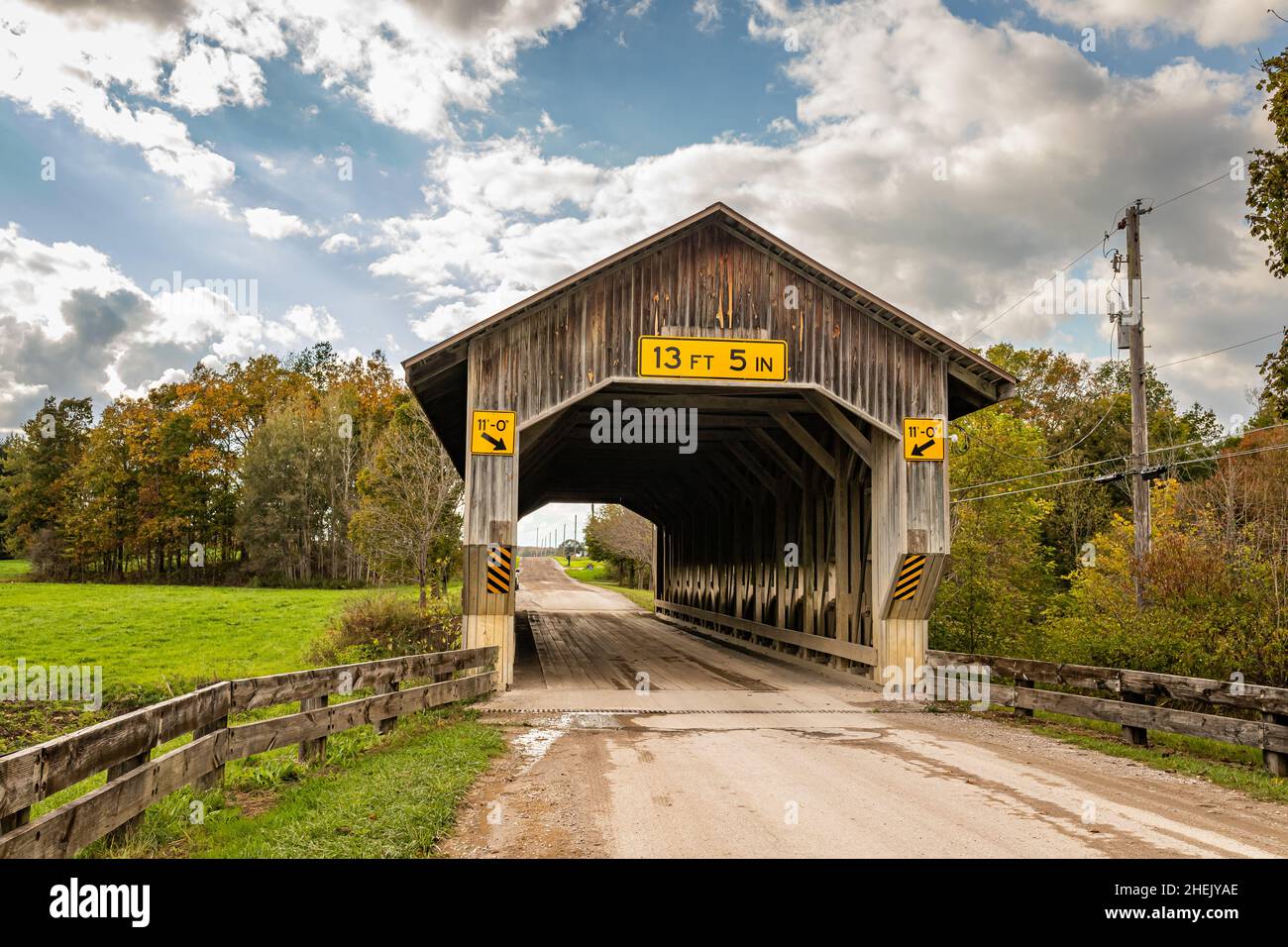 The Caine Road Covered Bridge crosses the Ashtabula River during the Autumn leaf color change in Ashtabula County, Ohio. Stock Photo