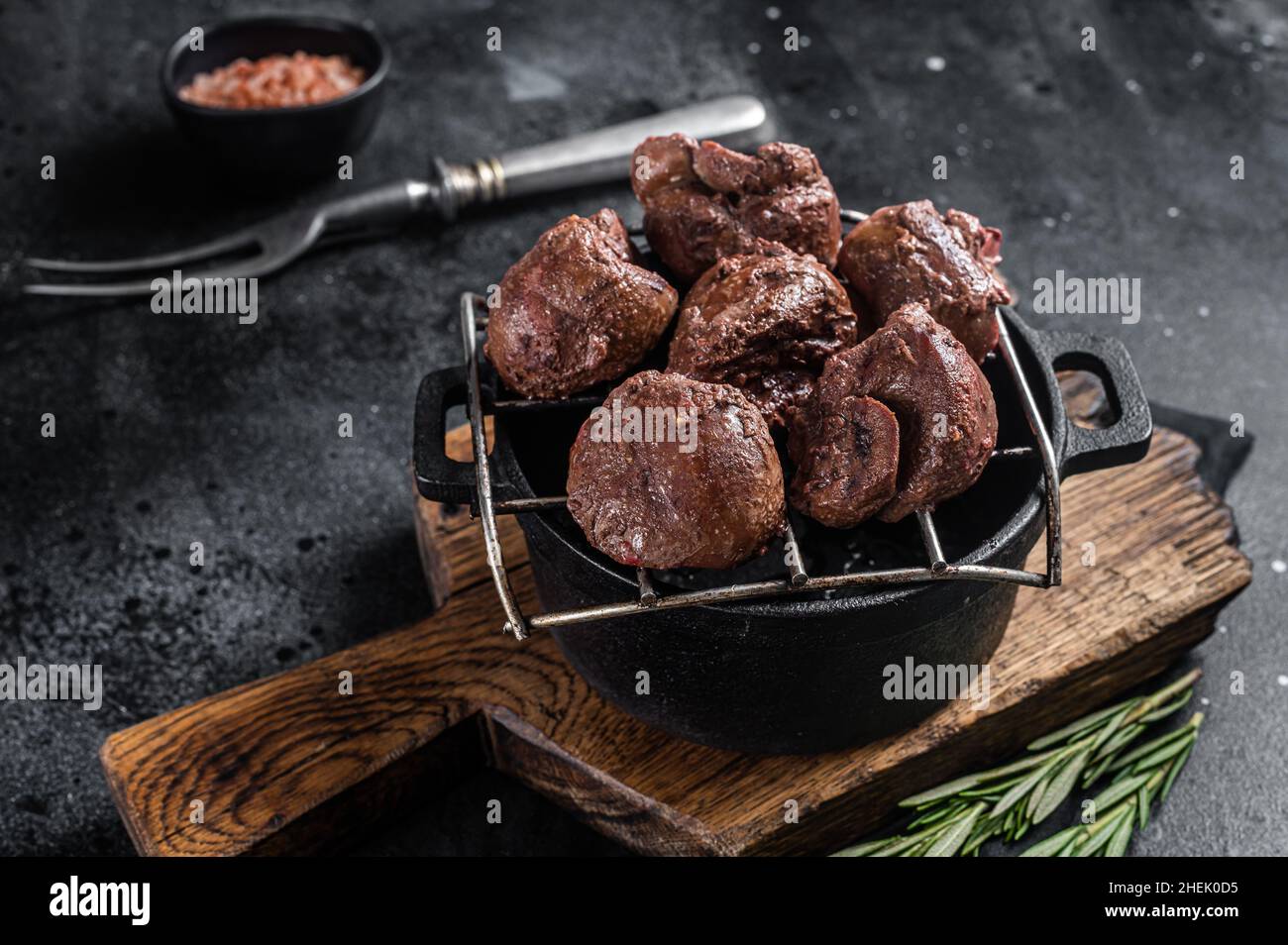 Grilled Beef veal kidney, offal meat on grill. Black background. Top