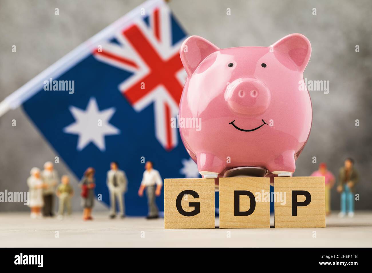 Piggy Bank Wooden Cubes With Text Plastic Toy Men And A Flag On An piggy-bank-wooden-cubes-with-text-plastic-toy-men-and-a-flag-on-an