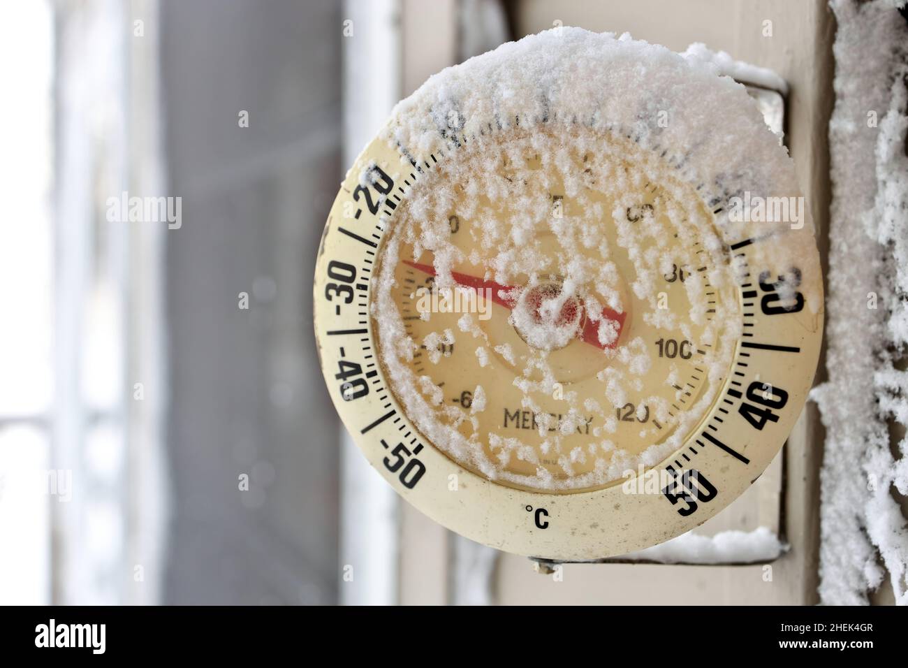 Frosty snow-capped outdoor Thermometer on a extremely cold, frigid winter's day Stock Photo