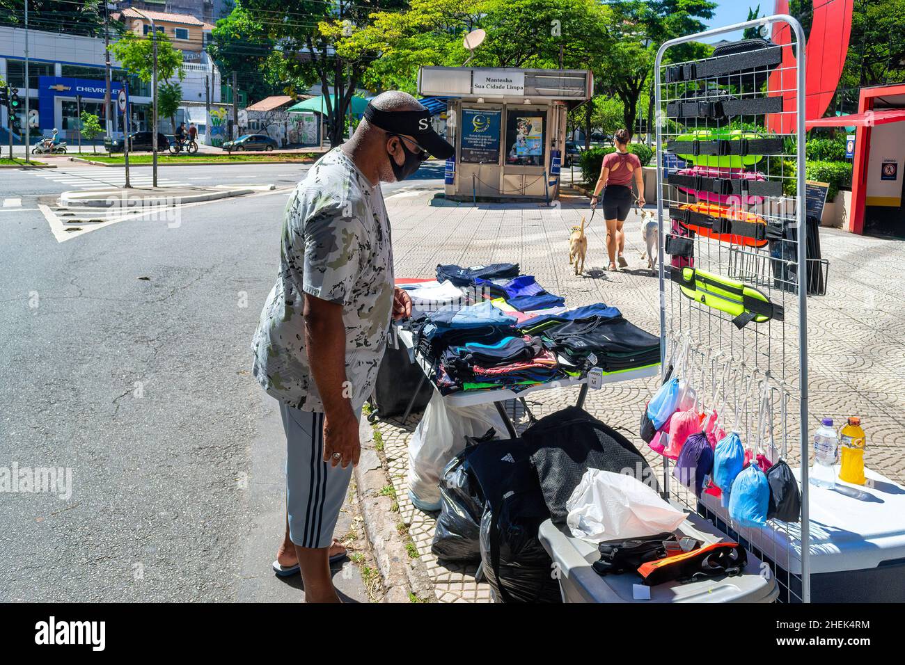 A Brazilian man browse items in a small street selling business in the Sumare district in Sao Paulo, Brazil. He wears a face mask. Stock Photo