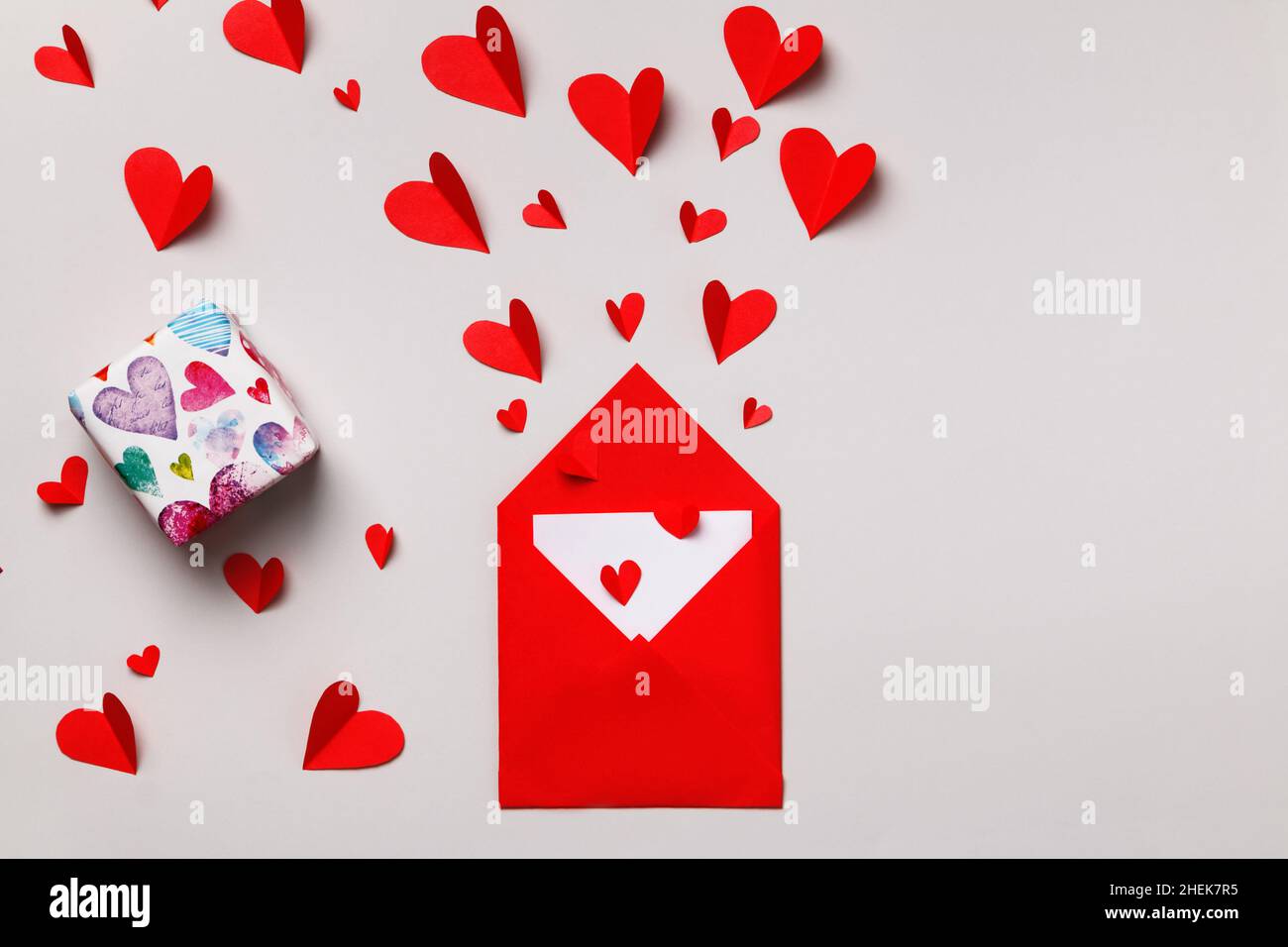 Love letter for Valentine's Day. Red paper envelope with a note inside ...