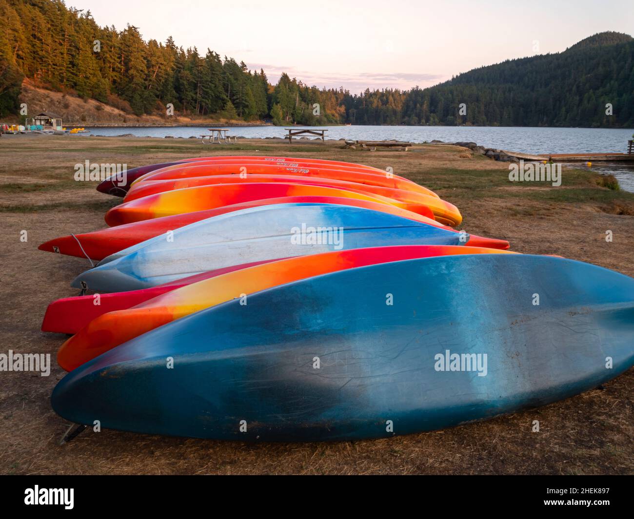 WA21054-00...WASHINGTON -Rental kayaks on the shore for the evening at Cascade Lake in Moran State Park on Orcas Island; one of the San Juan Islands. Stock Photo