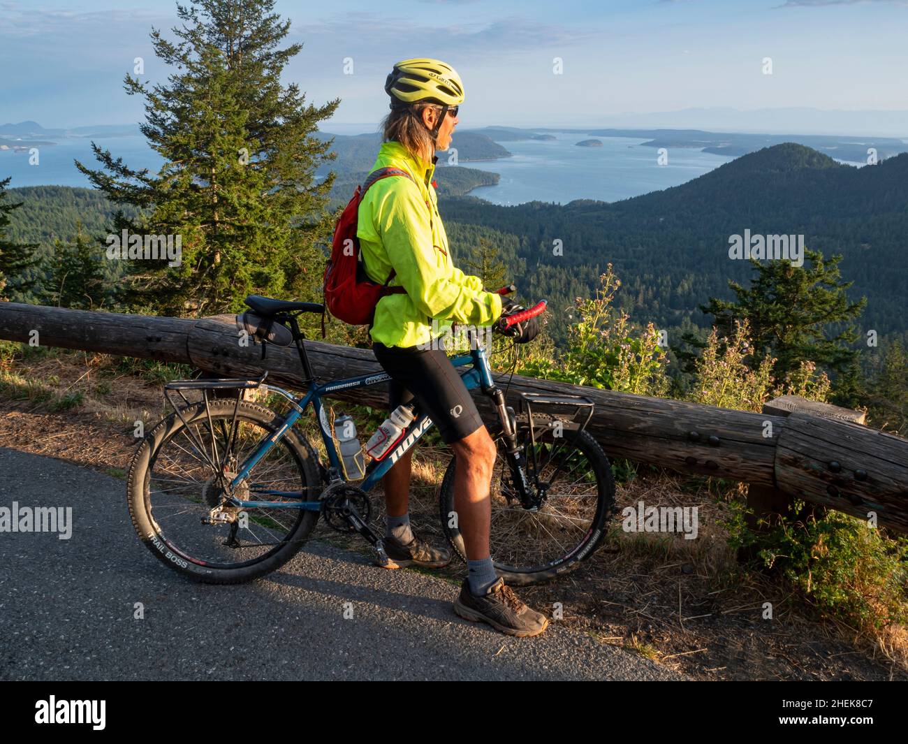 WA21052-00...WASHINGTON - Cyclist enjoying the view from the Mount Constitution Road in Moran State Park on Orcas Island; one of the San Juan Islands Stock Photo