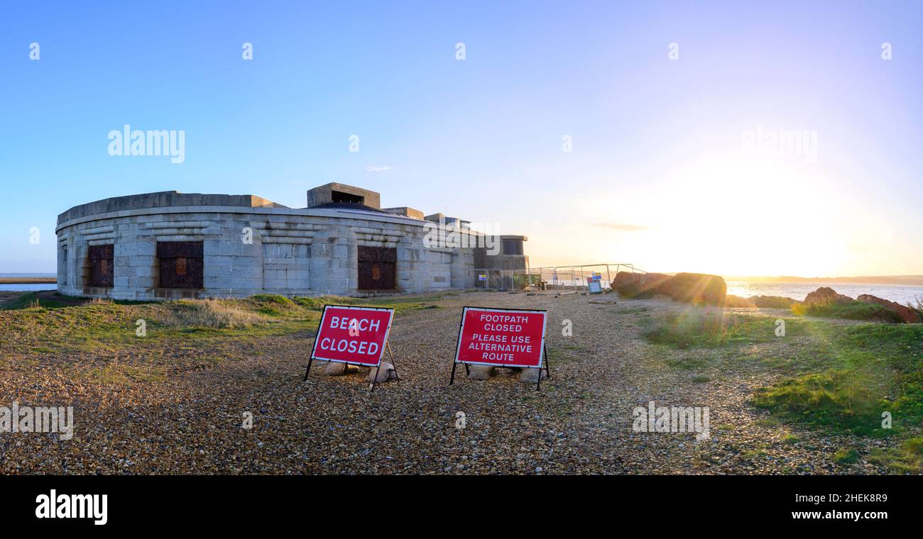 Sunrise at Hurst castle with closed warning signs on the beach path   due to the east wing collapsing  into the sea. Stock Photo