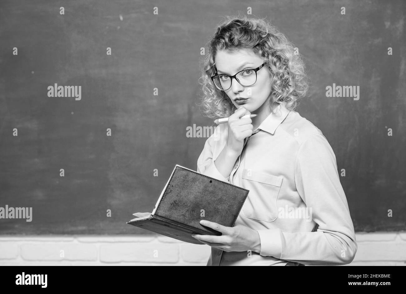 girl teacher at private lesson. concentrated student in glasses at blackboard. essay writing. teacher with notebook. next school year. Girl prepare Stock Photo