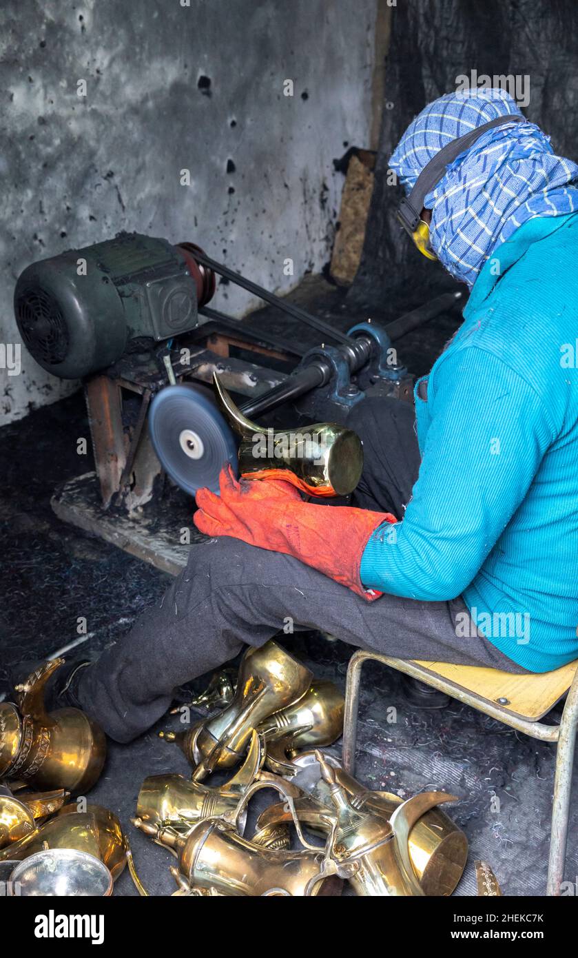 Ushaiqer, Saudi Arabia, 1st January 2022: man working in a dusty workshop, making arabic coffee pots Stock Photo