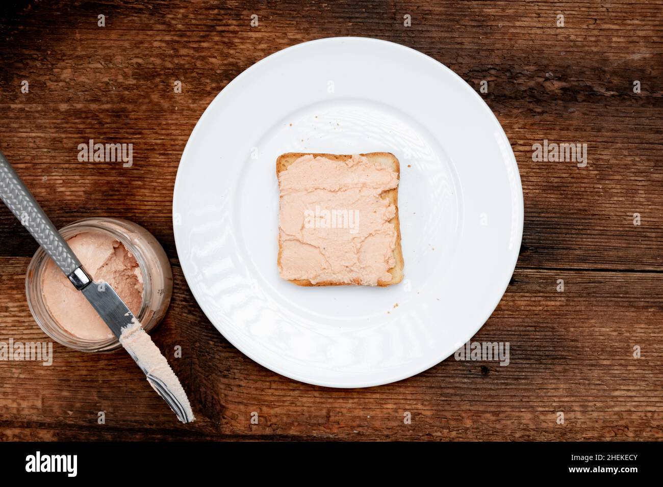 https://c8.alamy.com/comp/2HEKECY/on-toast-creamy-pasta-on-a-white-plate-dark-wooden-background-food-concept-a-quick-snack-top-view-2HEKECY.jpg