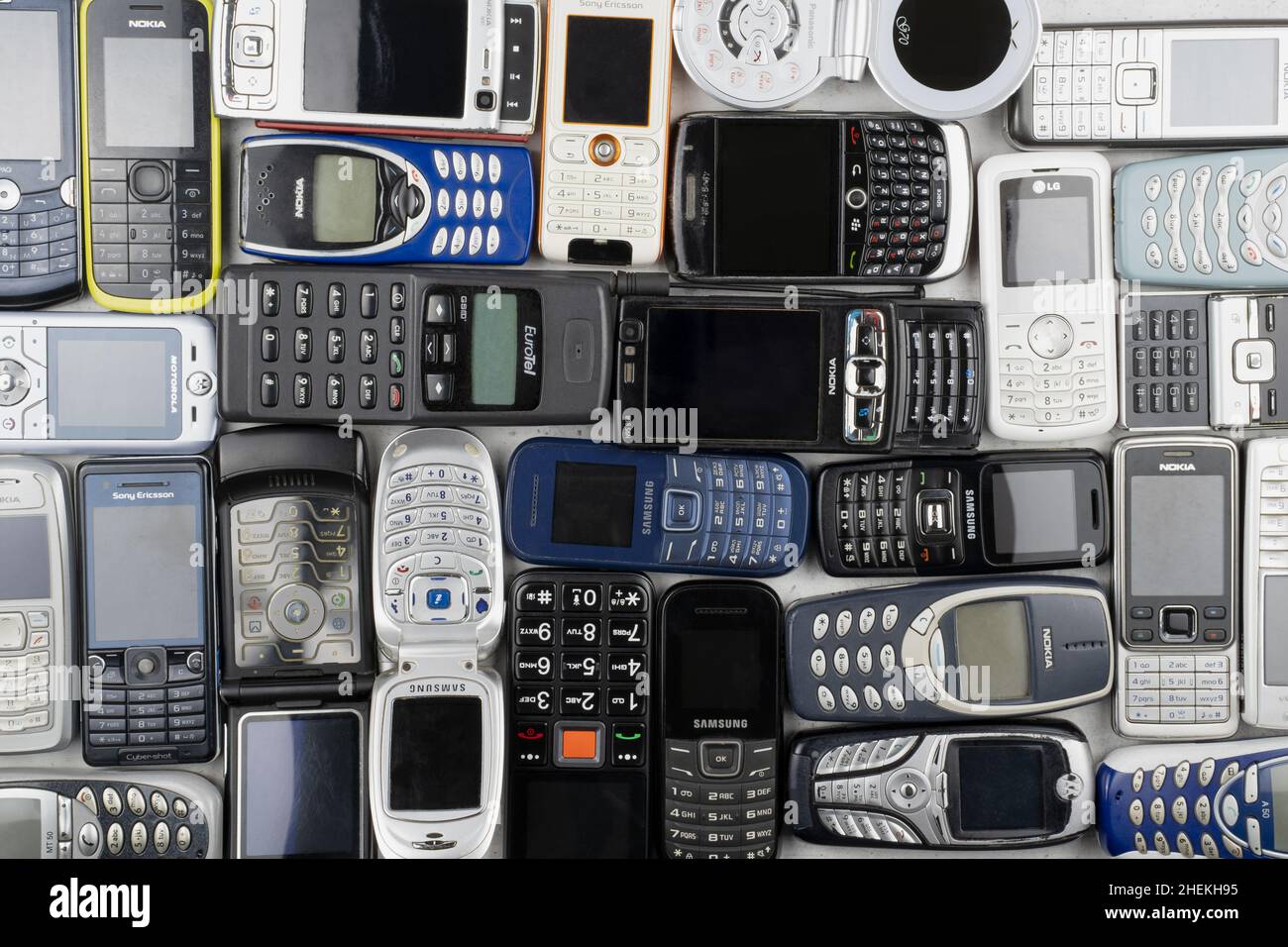 Prague, CZ -  12 December 2021:  A lot of old used mobile phones with keyboards, Various brands. Many types and generations of mobile smartphone gadge Stock Photo