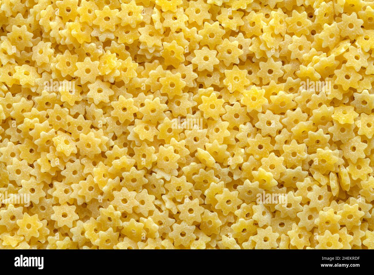 Large Pile of Dry Star Pasta Background Texture. Stock Photo