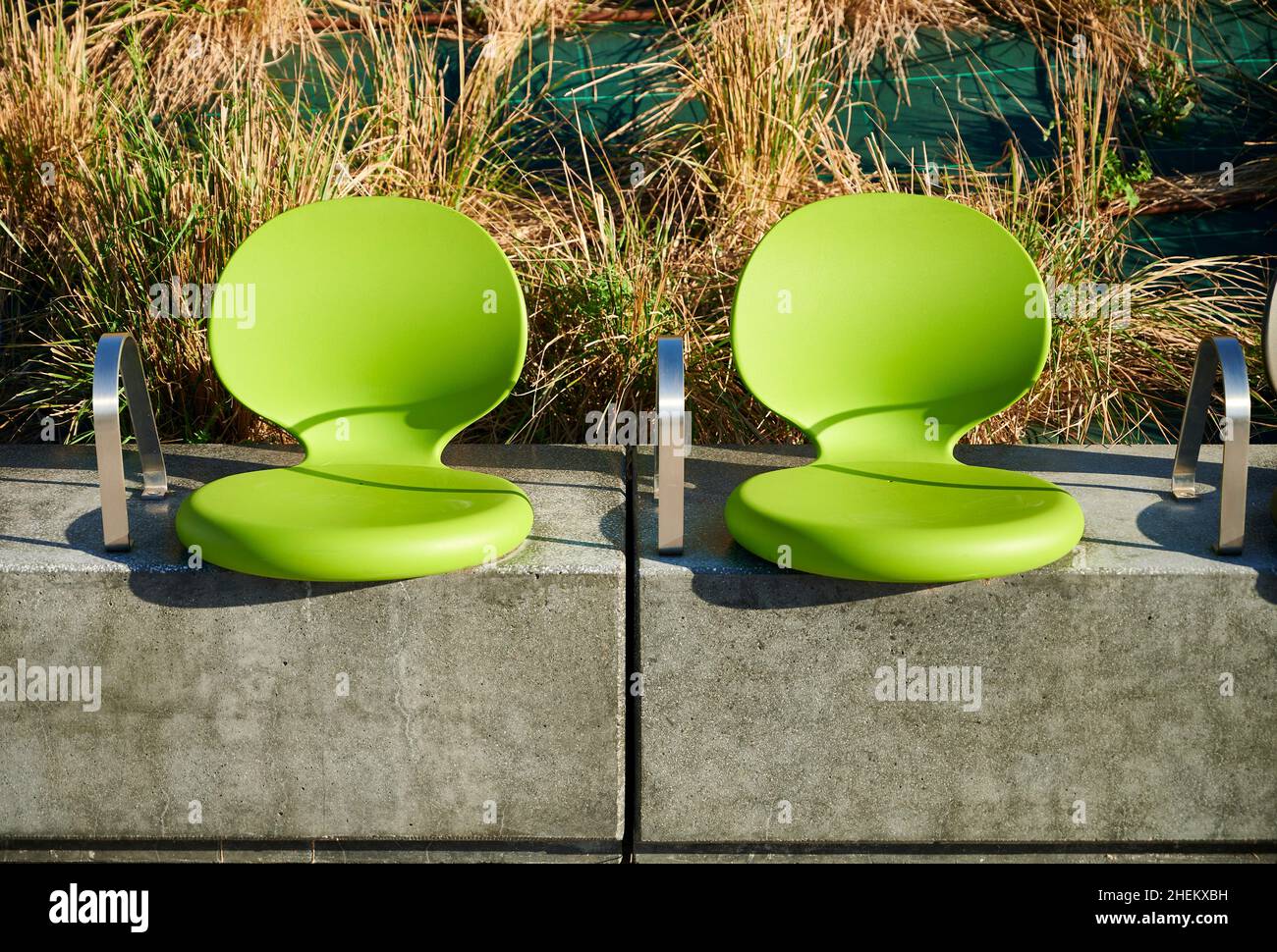Modern green seats located in the street for the rest of the