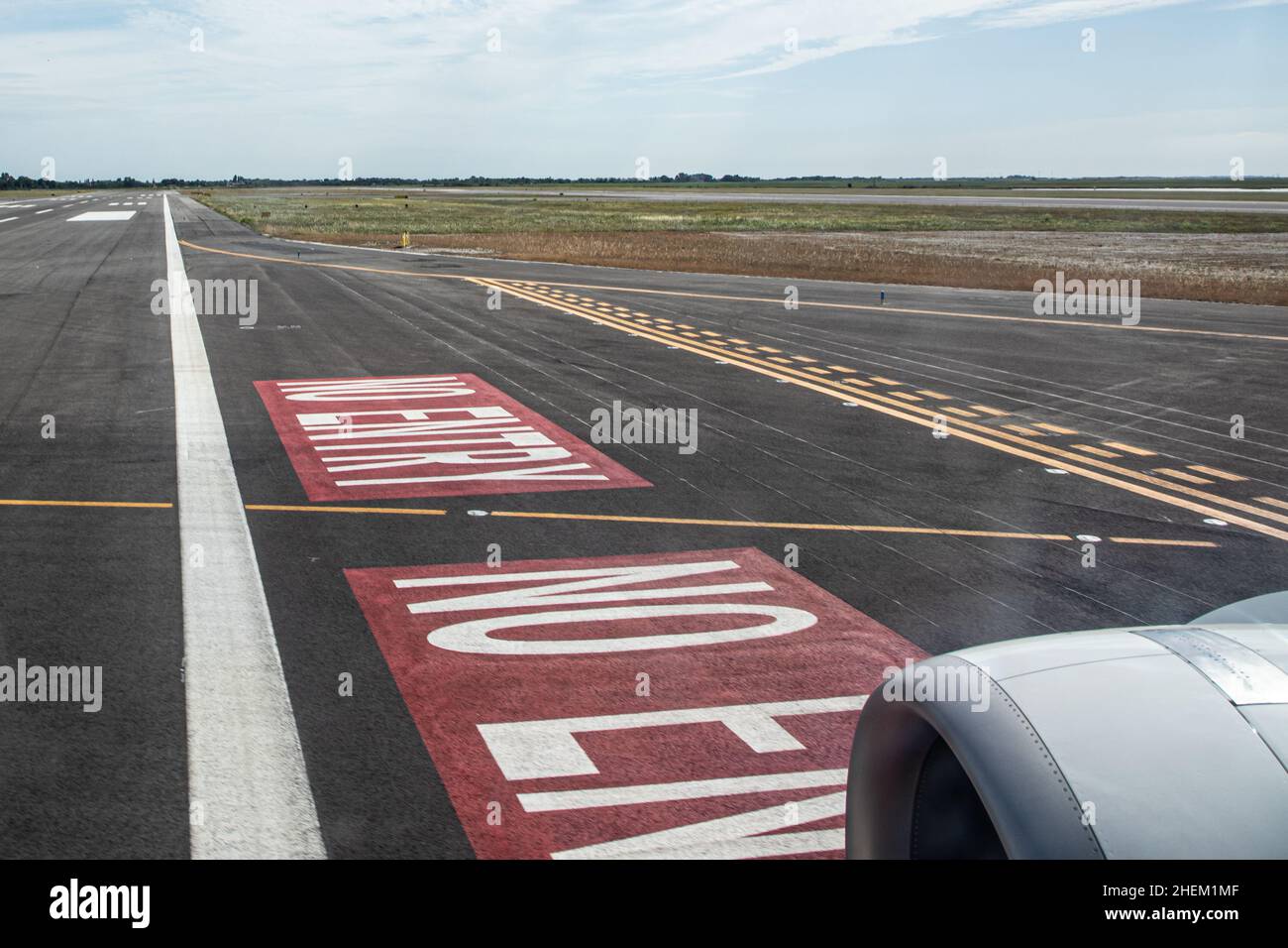 detail of touch down of aircraft with turbine and detail of runway