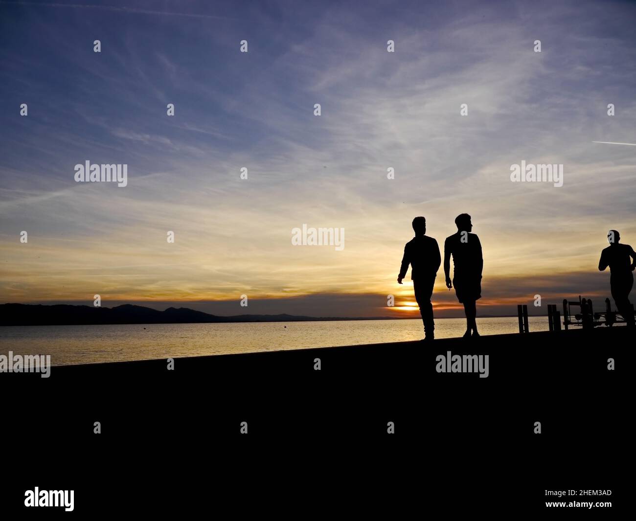 couple walking sunset Stock Photo - Alamy