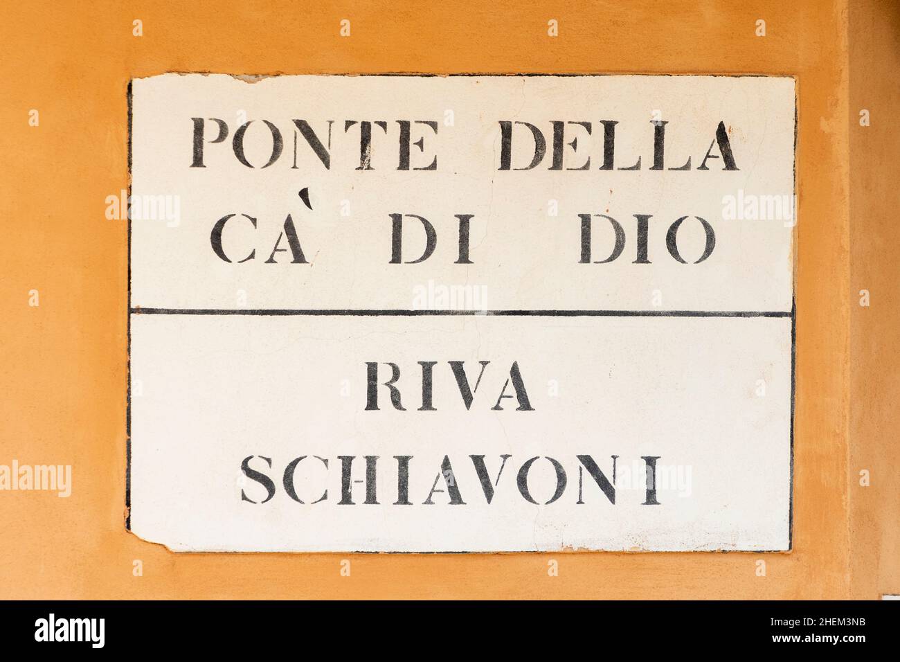 signage Ponte della ca di dio - bridge of God - and Riva Schiavoni - River Schiavoni - in Venice  at an old grunge house wall Stock Photo