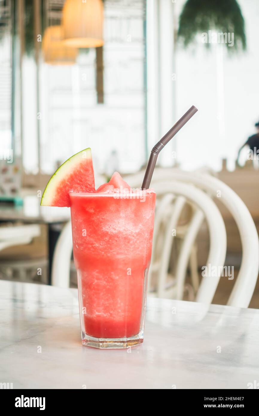 Iced watermelon juice glass on table in restaurant and cafe interior