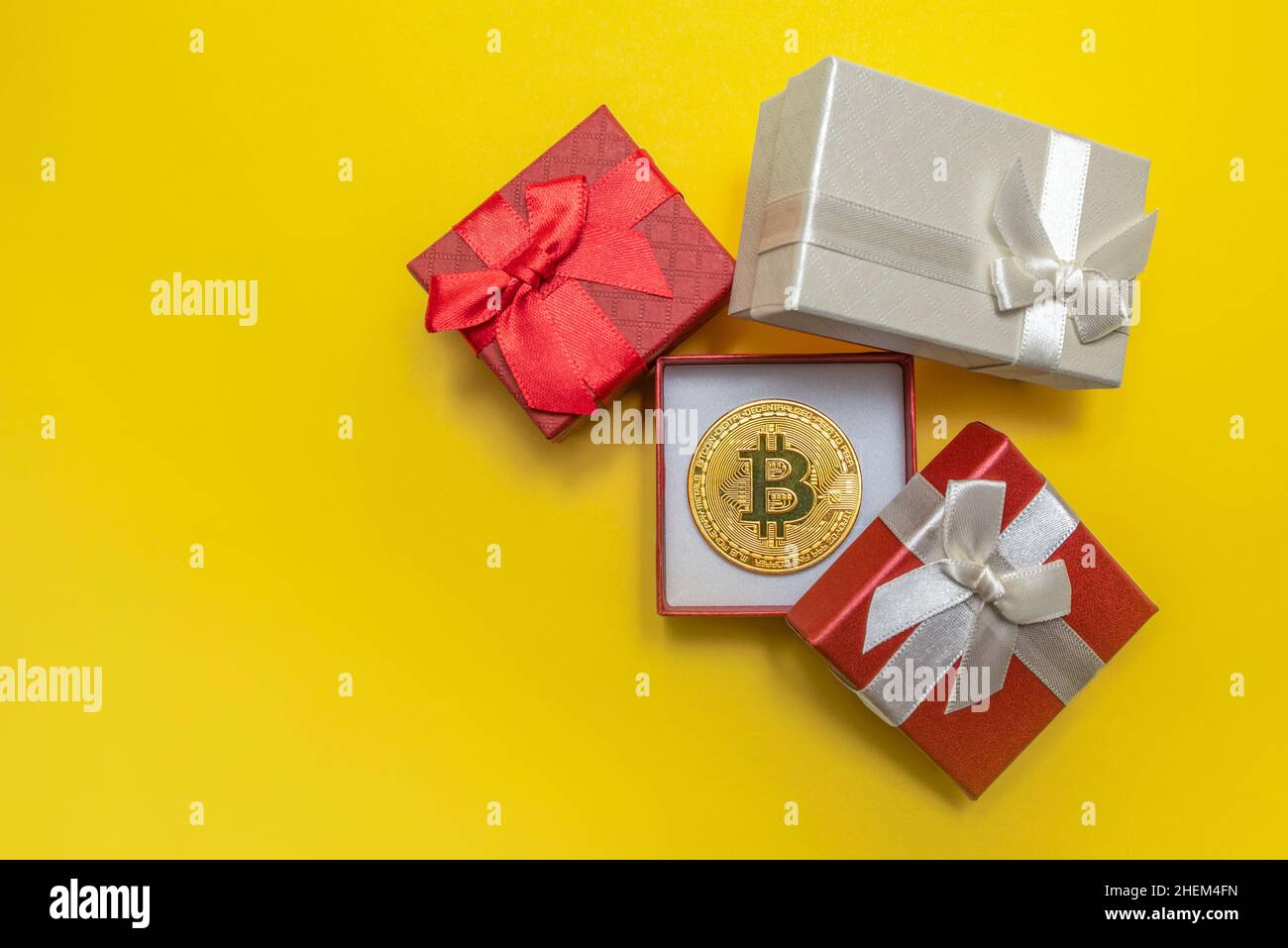 BTC gift. Bitcoin coin in a red gift box on a yellow background. Postcard  for printing, banner with place for text Stock Photo - Alamy