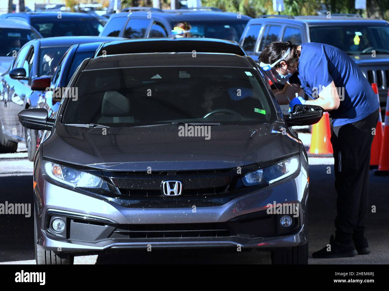 Orlando, United States. 11th Jan, 2022. Healthcare workers collect nasal swab samples at a drive-thru COVID-19 testing site at Camping World Stadium. This is the fourth mass testing site that has opened in the area in recent weeks as Florida continues to break infection records due to the spread of the Omicron variant. (Photo by Paul Hennessy/SOPA Images/Sipa USA) Credit: Sipa USA/Alamy Live News Stock Photo