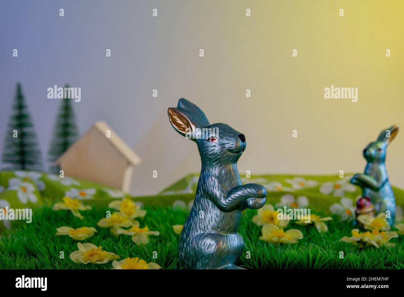 Easter bunny on meadowland with flowers decoration still life Stock Photo