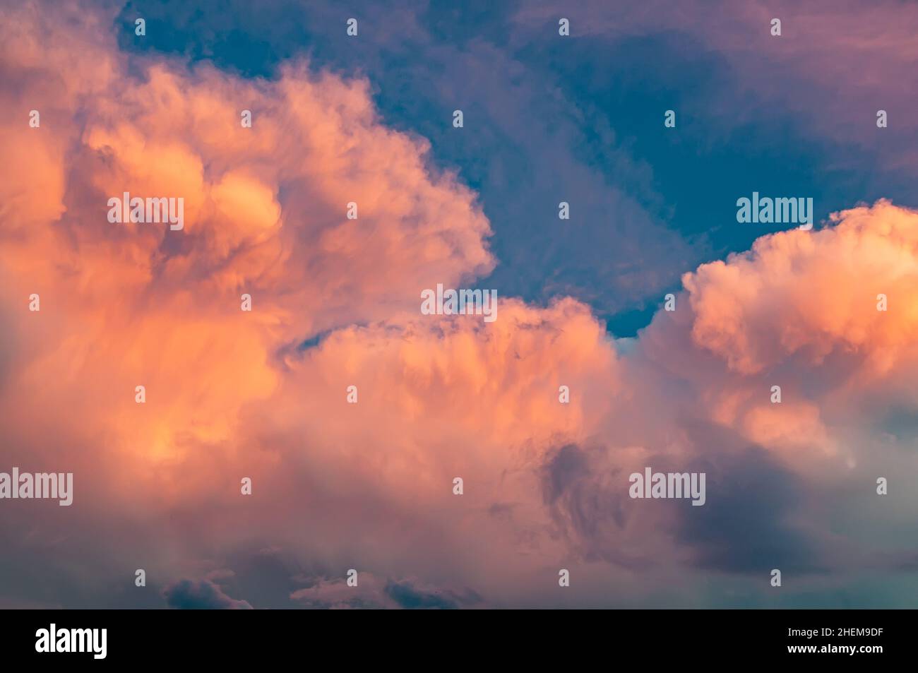 Pink clouds at sunset, unusual shape and color of the sky. Background with beautiful and bright