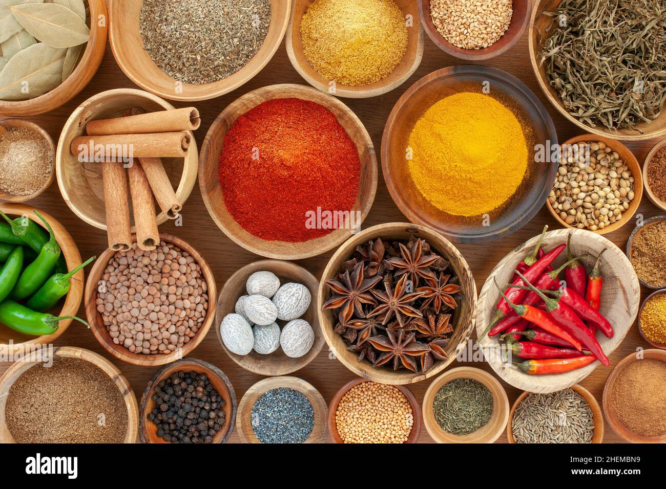 Overhead shot of a variety of spices in a variety of different wooden bowls. Stock Photo