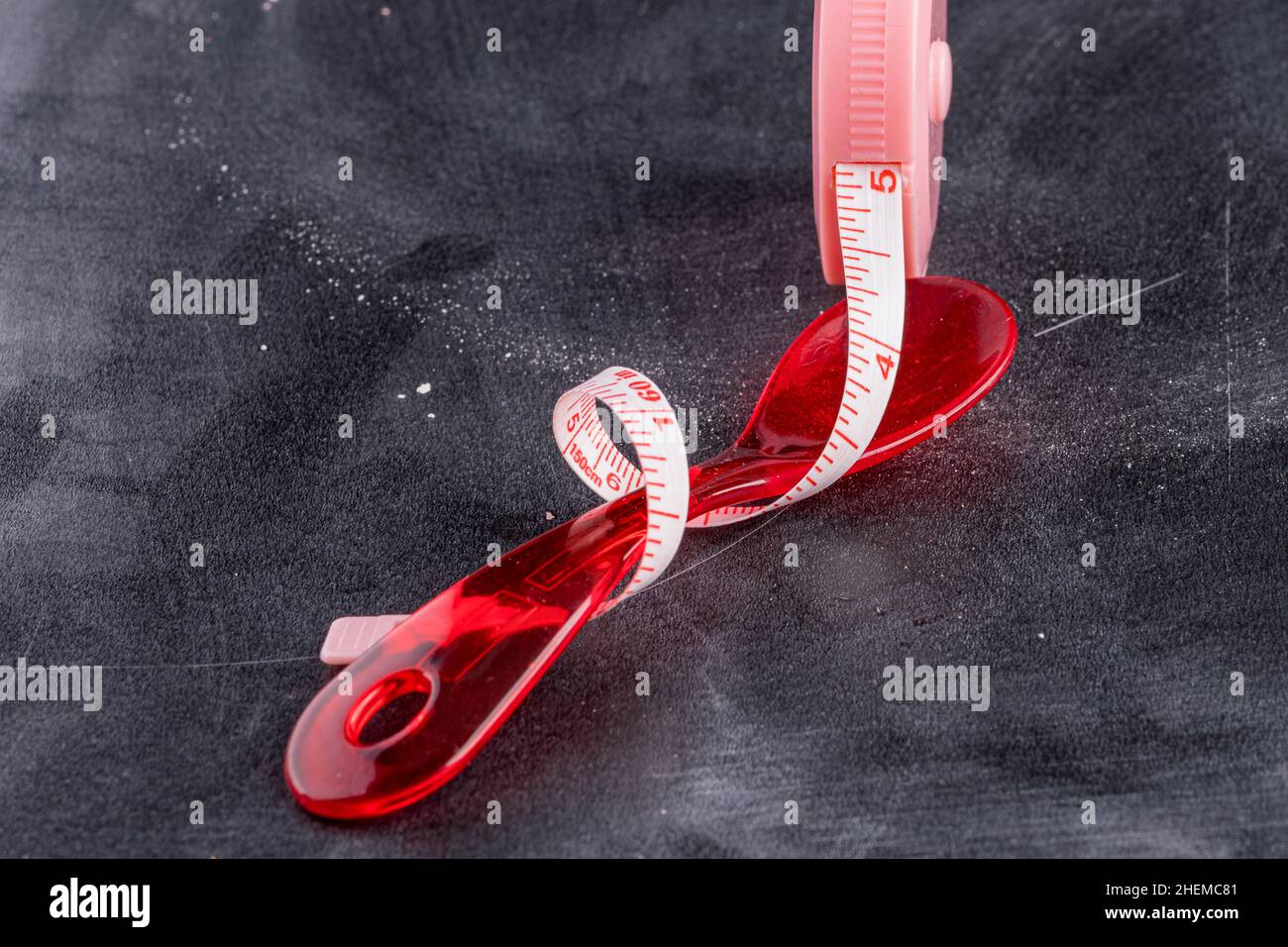 Measuring tape with red plastic spoon Stock Photo