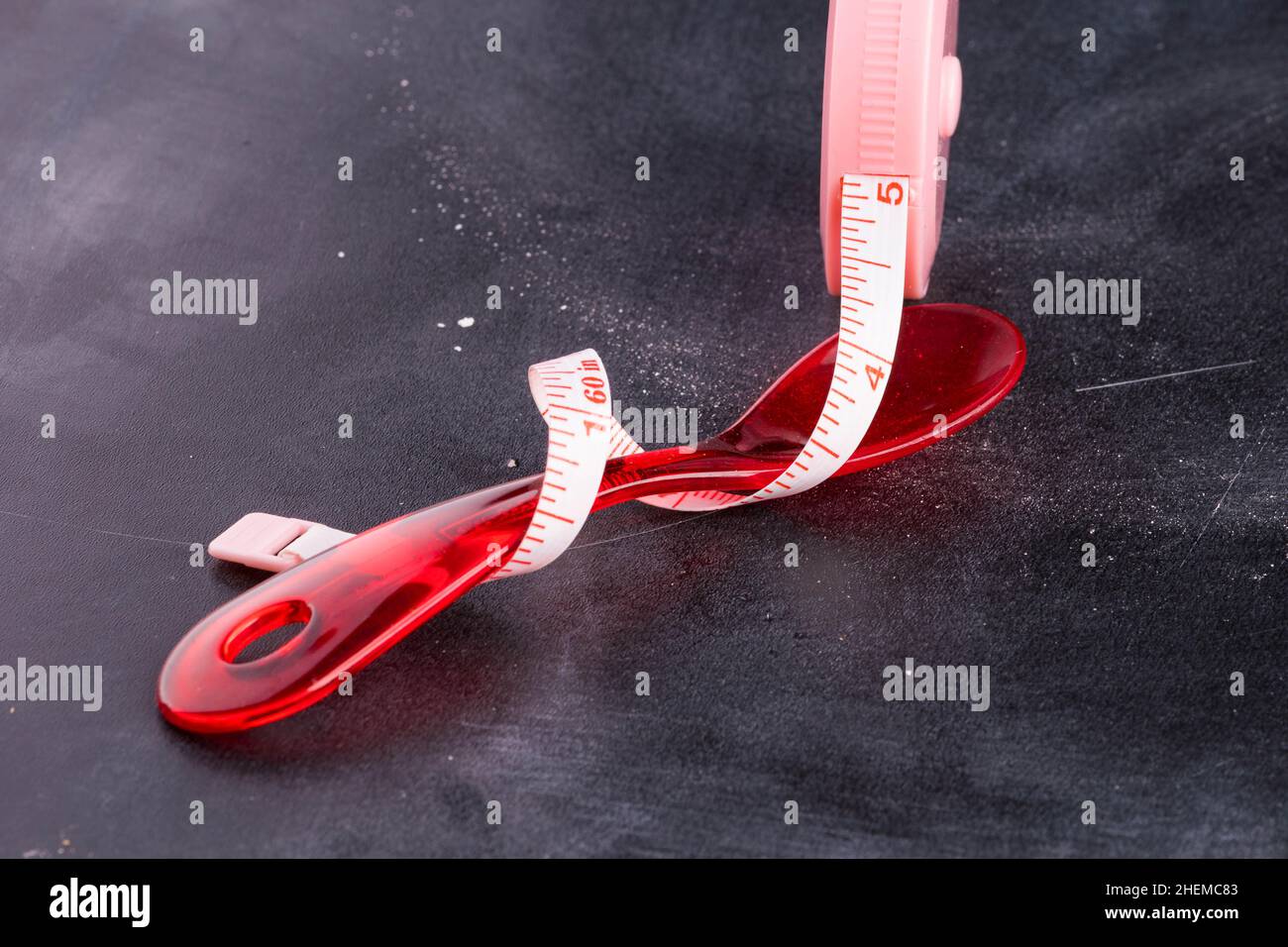 Measuring tape with red plastic spoon Stock Photo