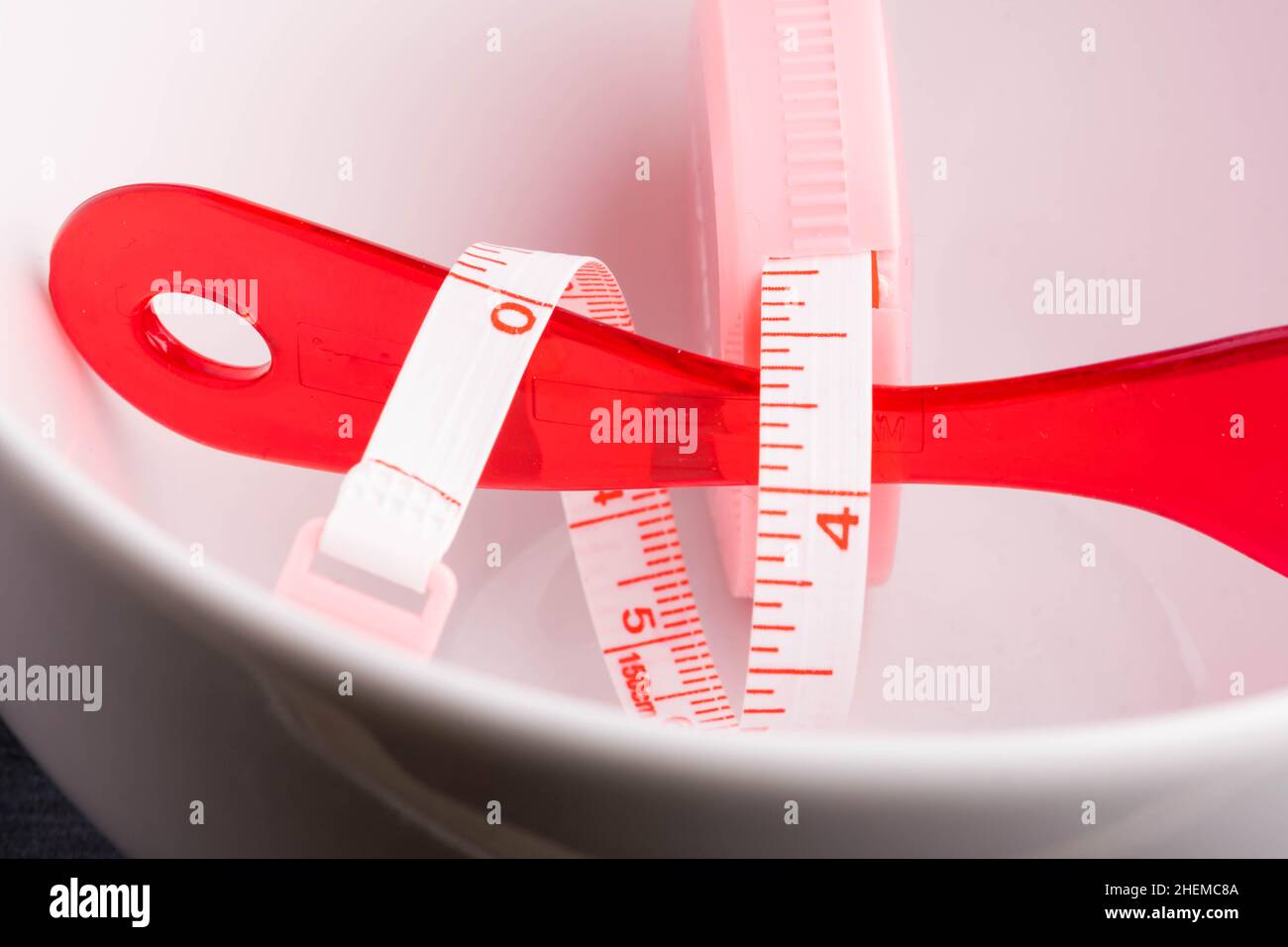 Bowl Measuring tape with red plastic spoon Stock Photo
