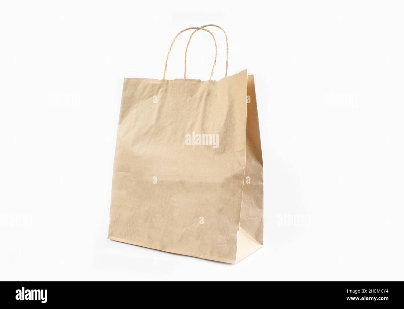 Brown paper bag with handles isolated on white background Stock Photo
