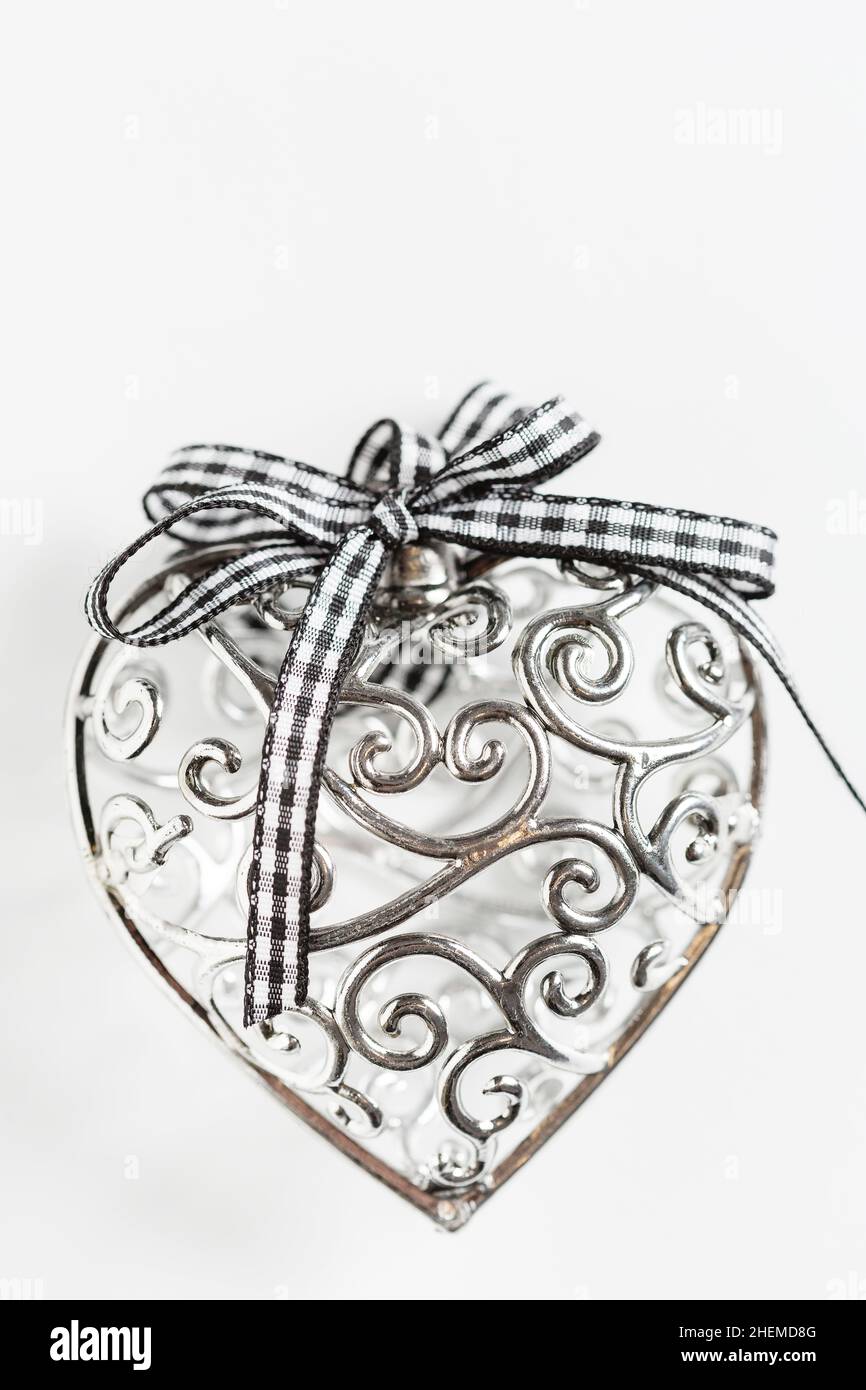 Saint Valentine day greeting card, beautiful silver heart with ribbon on white background Stock Photo