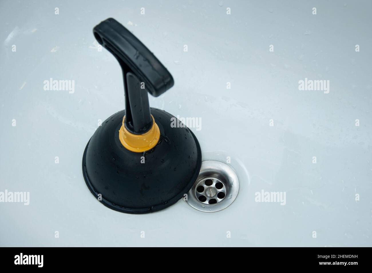 Plunger and clogged sink. Pipe cleaning concept. Sanitary engineering