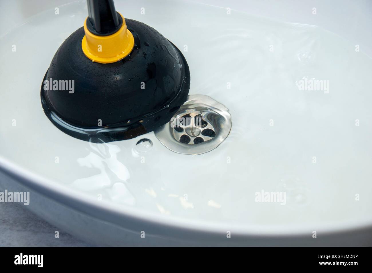 Concept of unclog blockages with a plunger. Clogged pipes and sink in ...