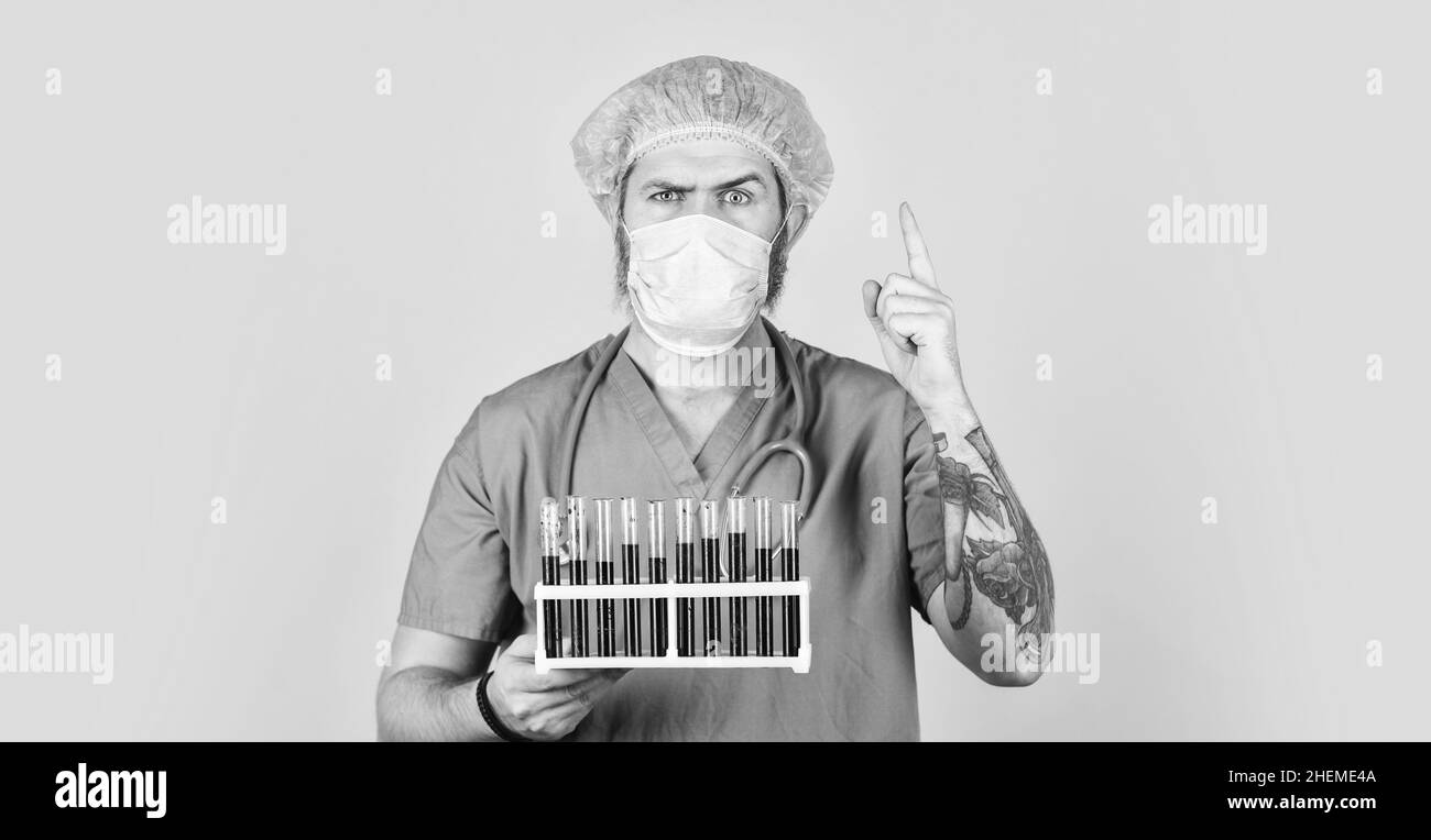 Quarantine plans. Epidemic threshold. Medical research. Man in medical lab inspecting samples biological material. Test tubes. Epidemic disease. Virus Stock Photo