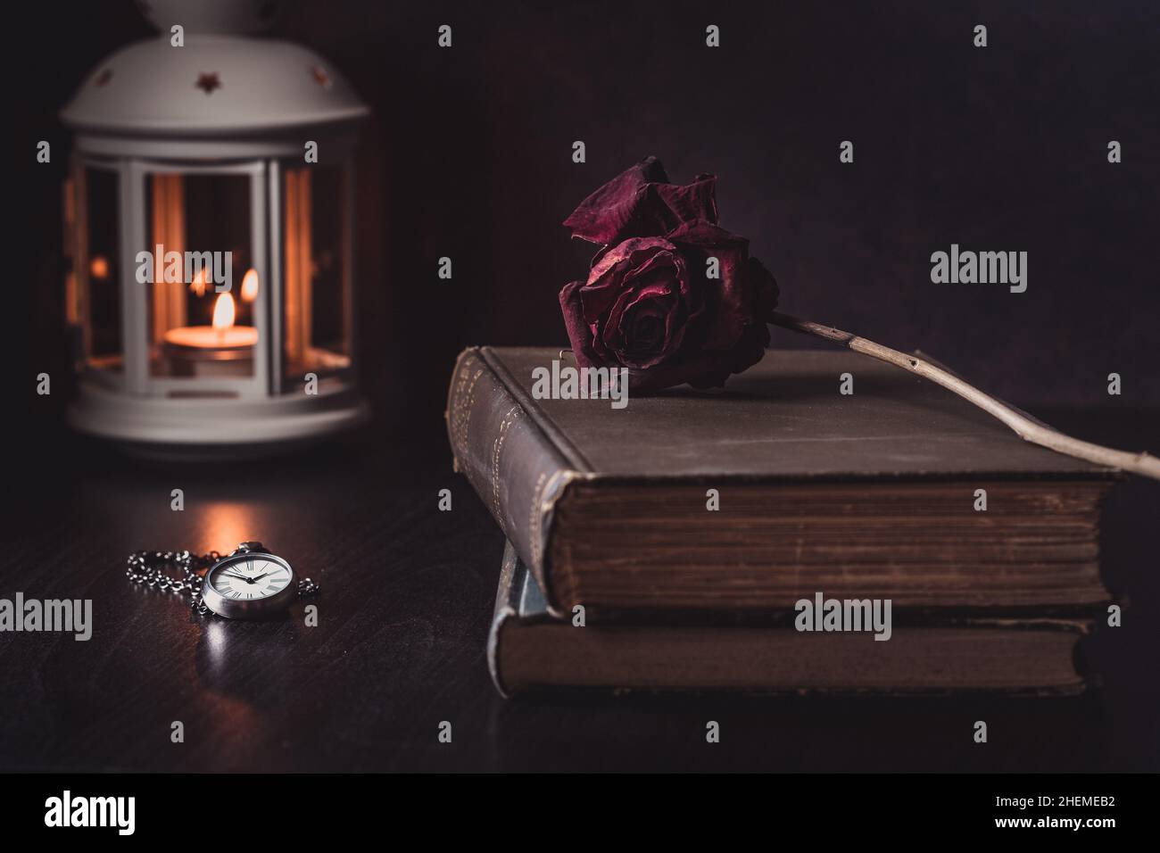Vintage Still Life of Rose on Old Books with Clock and Lantern Stock ...