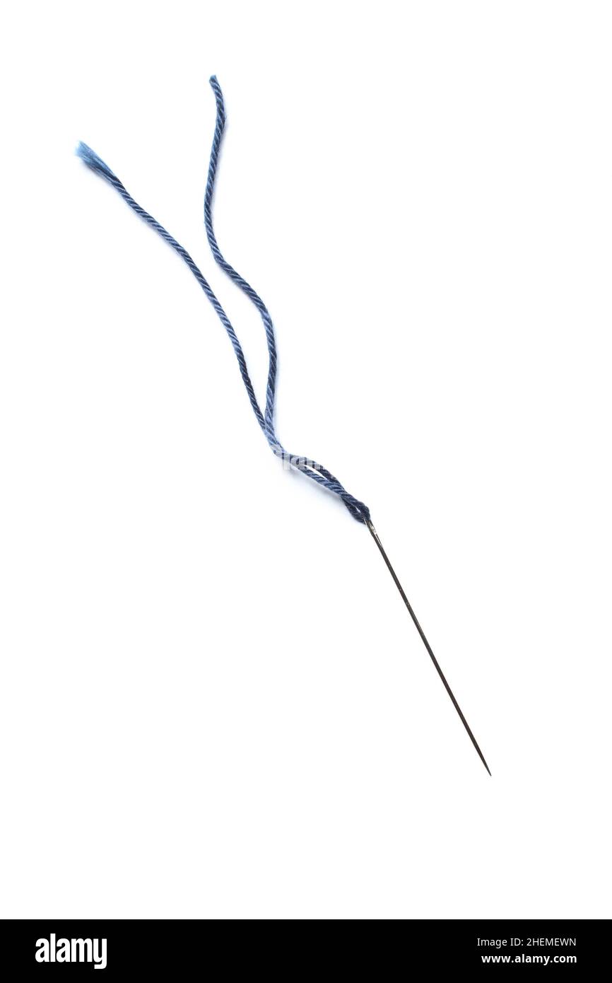 Metallic needle and blue thread isolated on white background Stock Photo